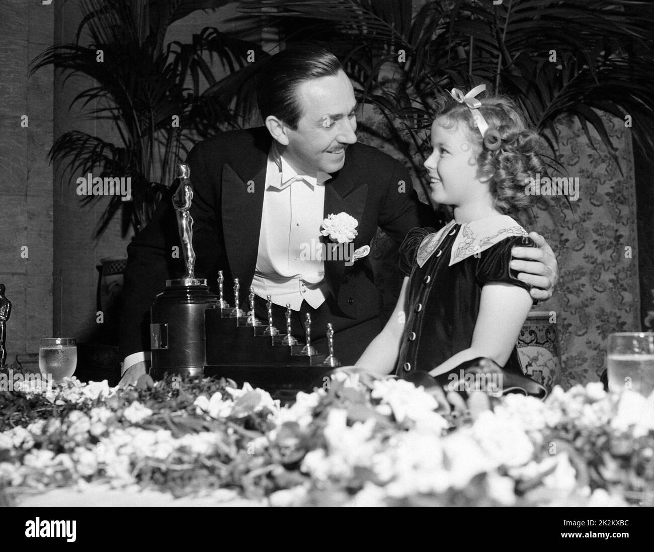 Shirley Temple and Walt Disney, Oscars ceremony in 1935. Shirley Temple receives the Juvenile Award In grateful recognition of her outstanding contribution to screen entertainment during the year 1934. Stock Photo