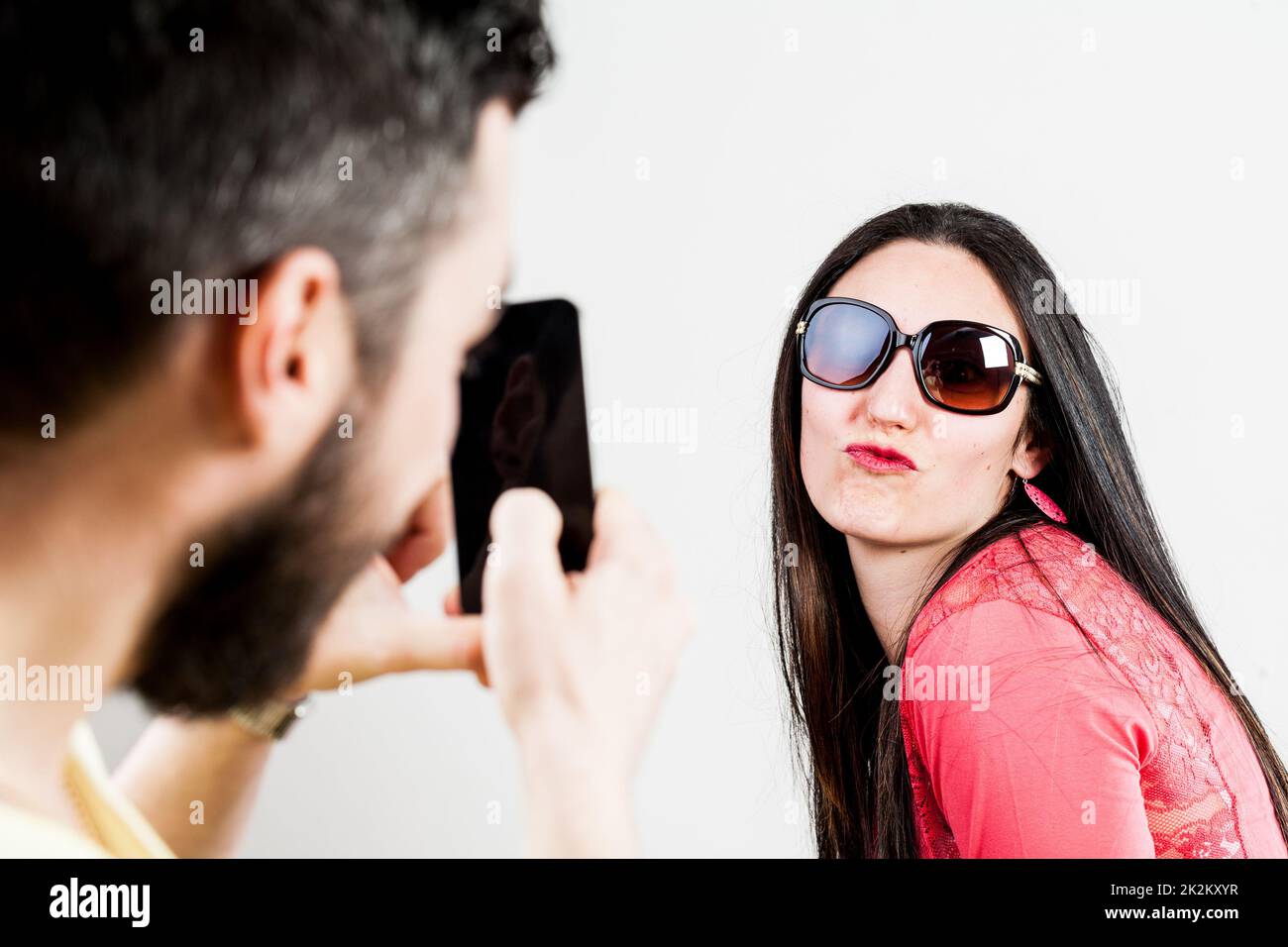 thrilled couple taking mobile photographs and selfies Stock Photo - Alamy