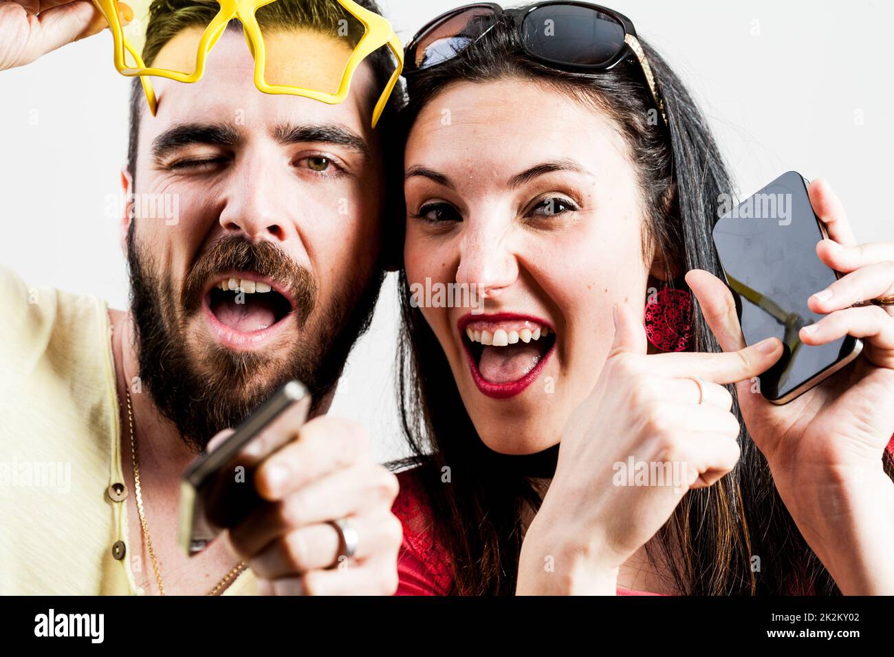 thrilled couple taking mobile photographs and selfies Stock Photo - Alamy