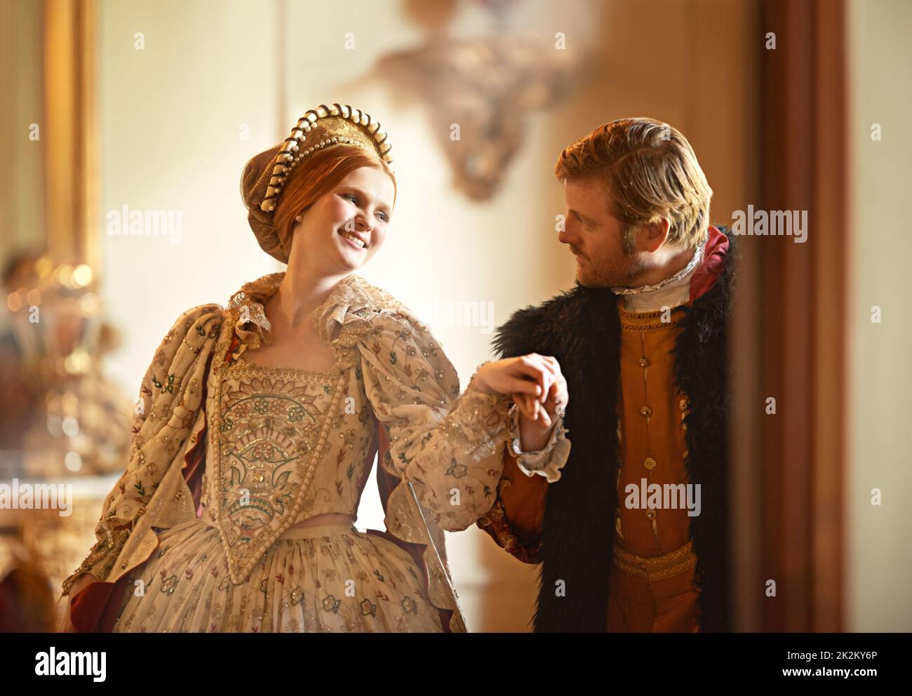 Allow me....A king and queen dancing together in their palace. Stock Photo