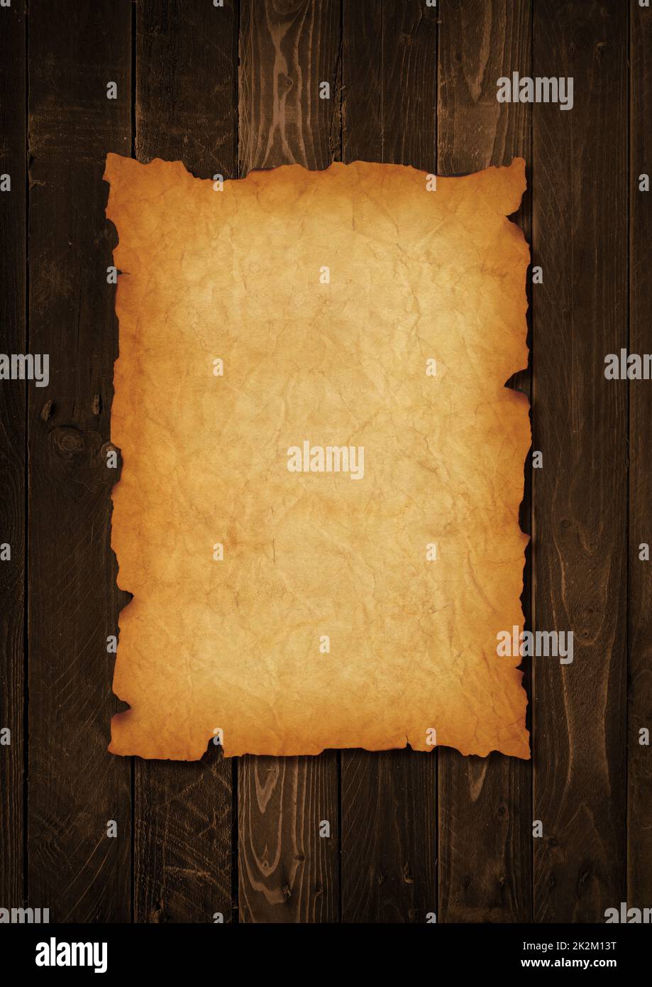 Old mediaeval paper sheet. Parchment scroll on a wood board Stock Photo