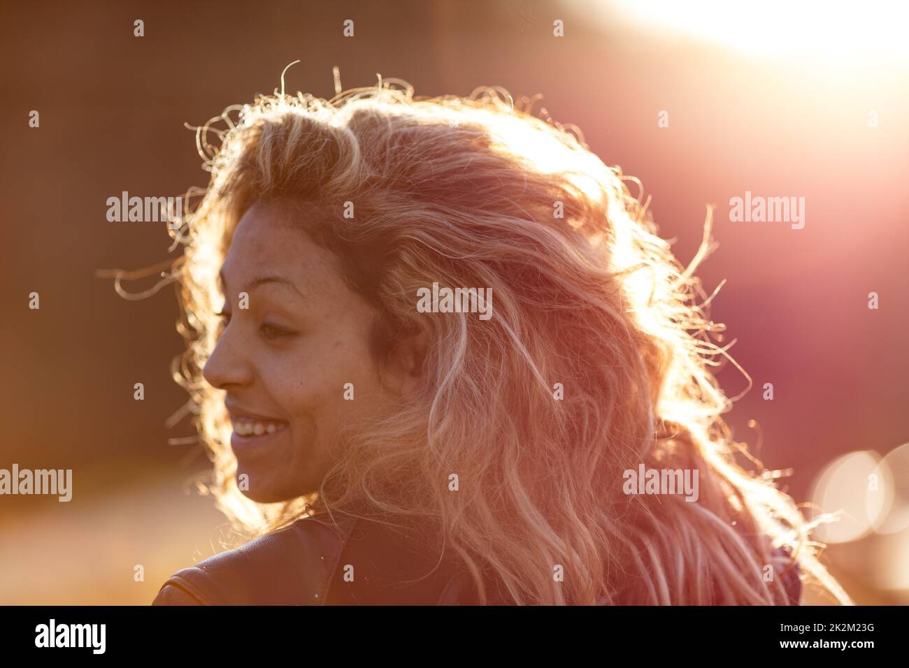 sunlight brushing motorbiker hair (woman) Stock Photo