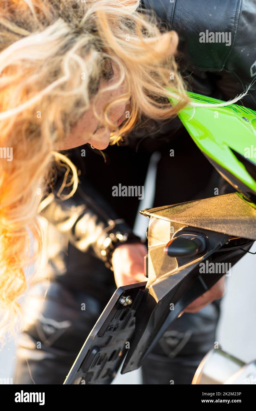 woman setting up her motorcycle to run Stock Photo