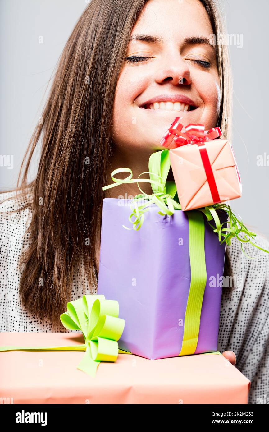 delighted woman with colorful packets Stock Photo