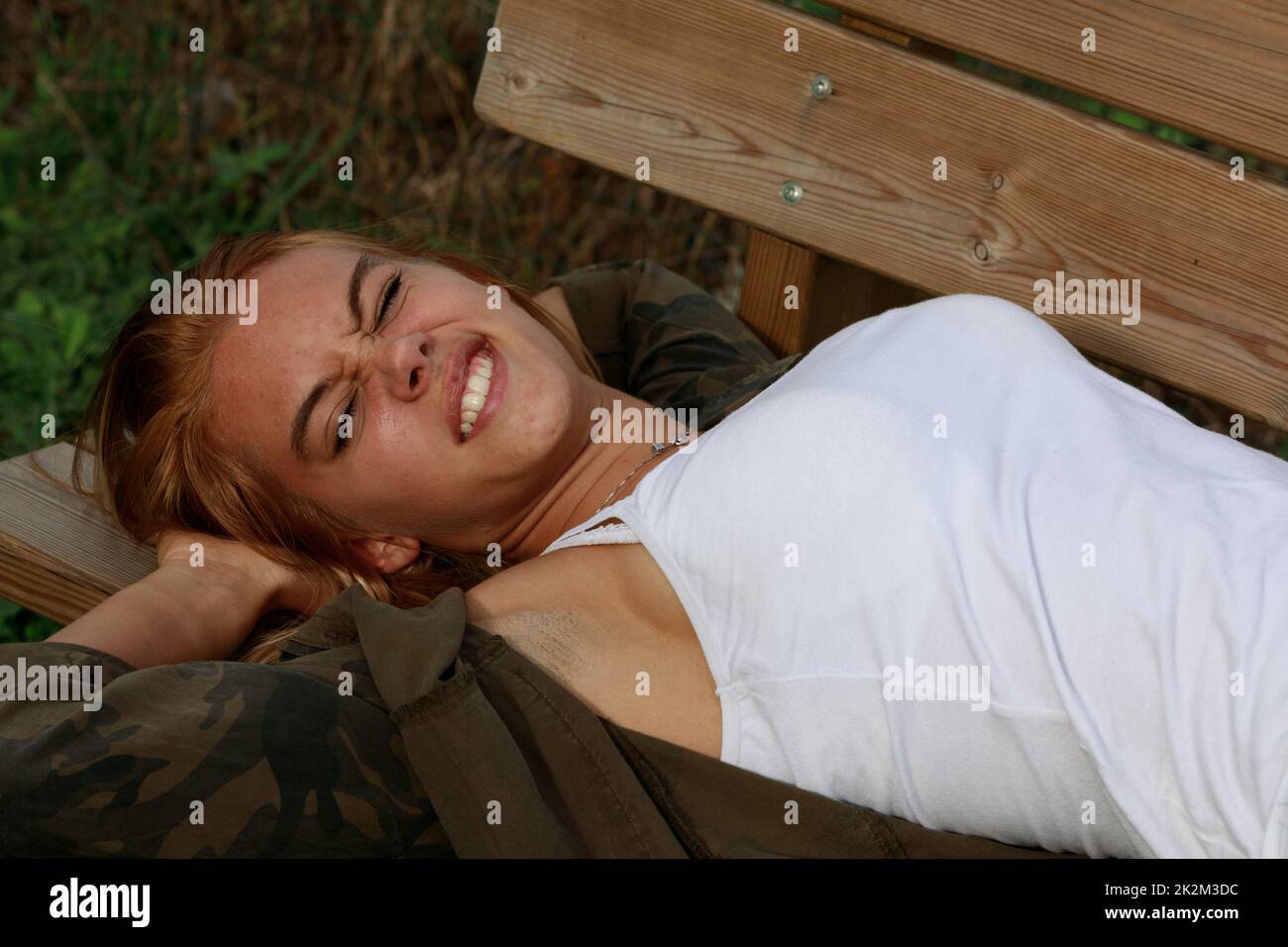 Young woman grimacing in distaste and aversion Stock Photo