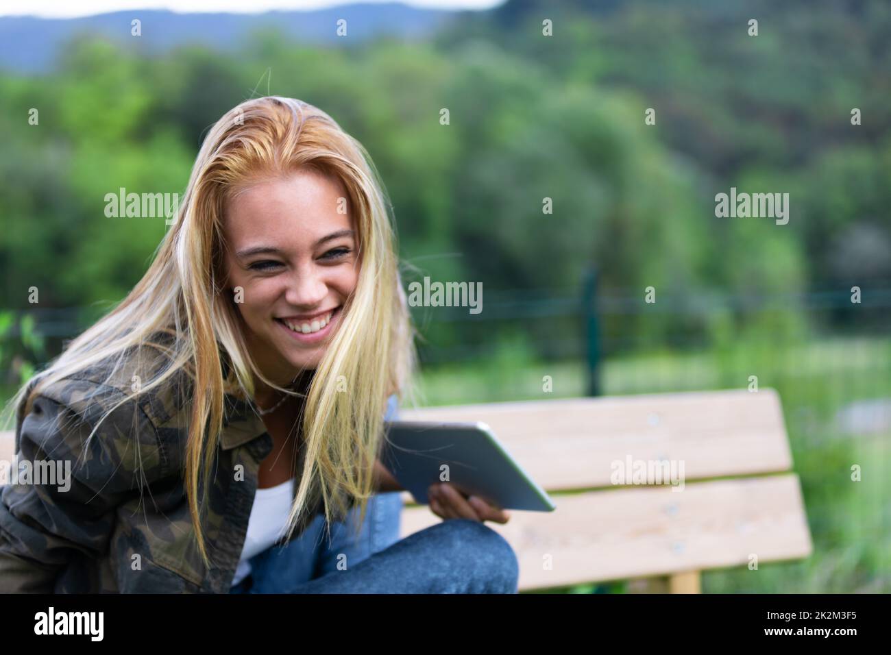 Fun playful young woman laughing at the camera Stock Photo