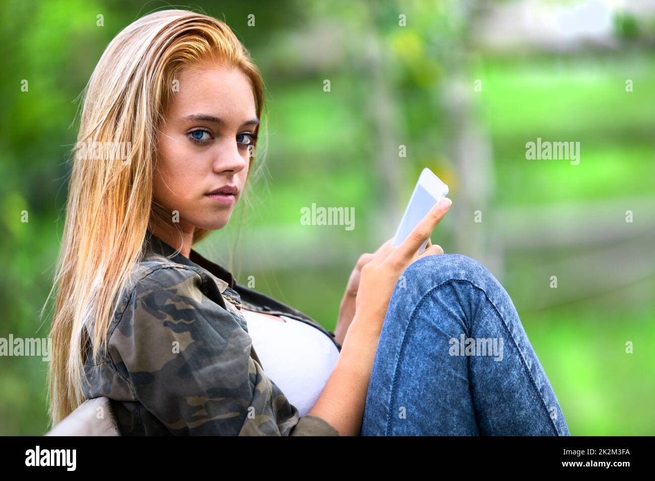 Sultry serious young woman looking aside at camera Stock Photo