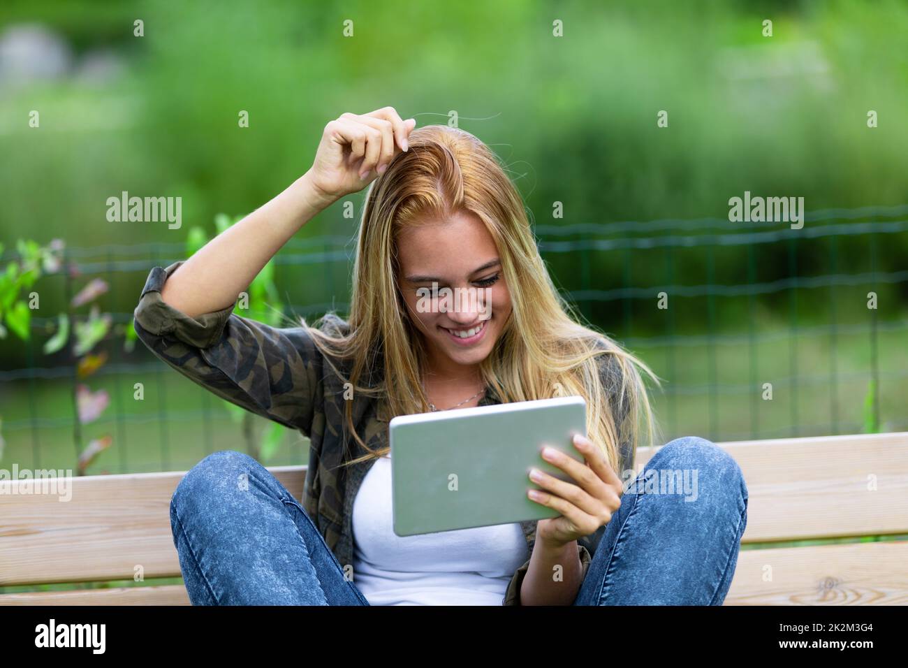 Happy smiling young woman scratching her head Stock Photo