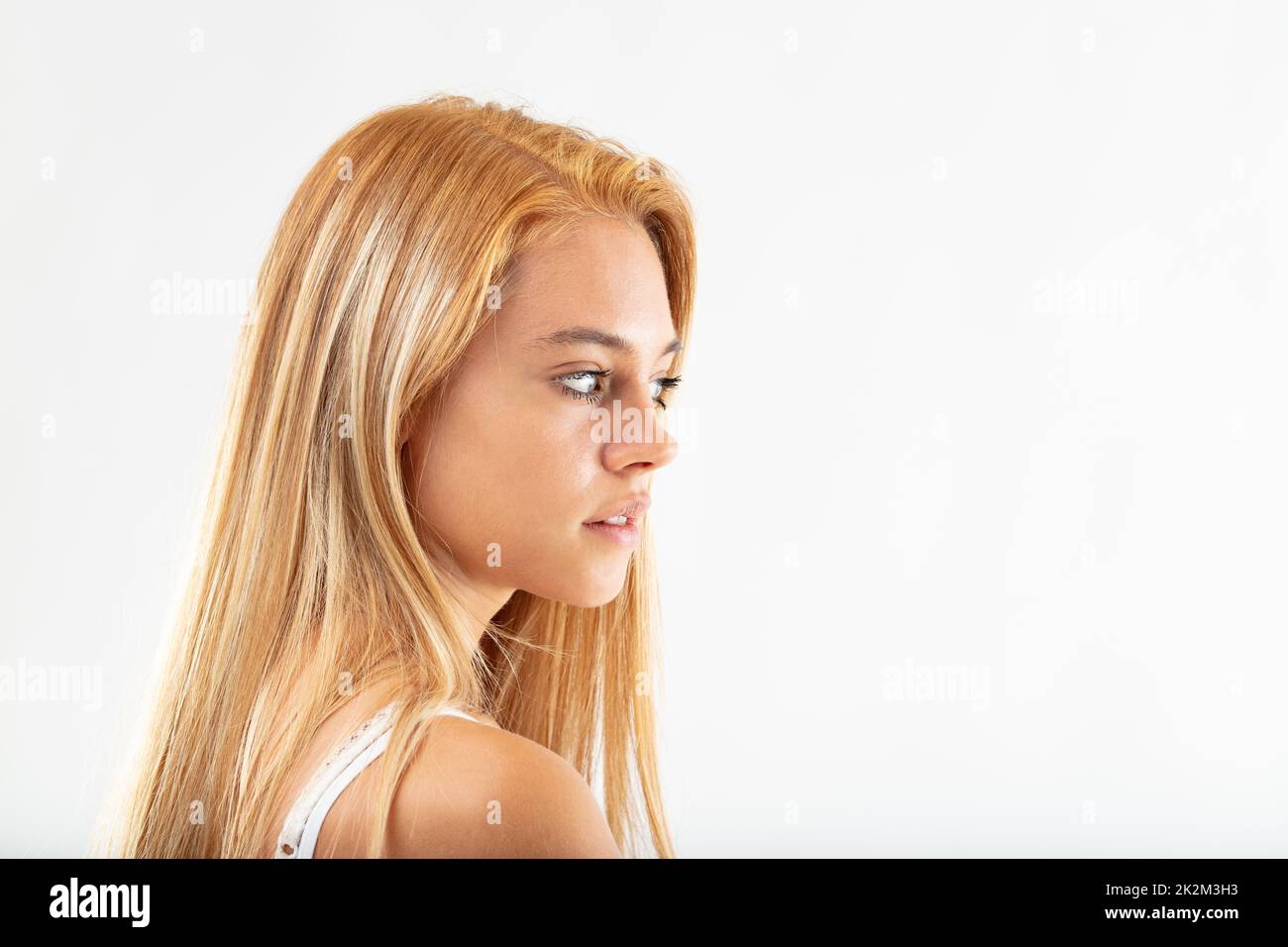 Pretty thoughtful young woman glancing aside Stock Photo