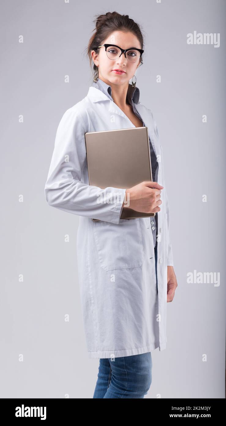 Serious lady doctor carrying a tablet Stock Photo