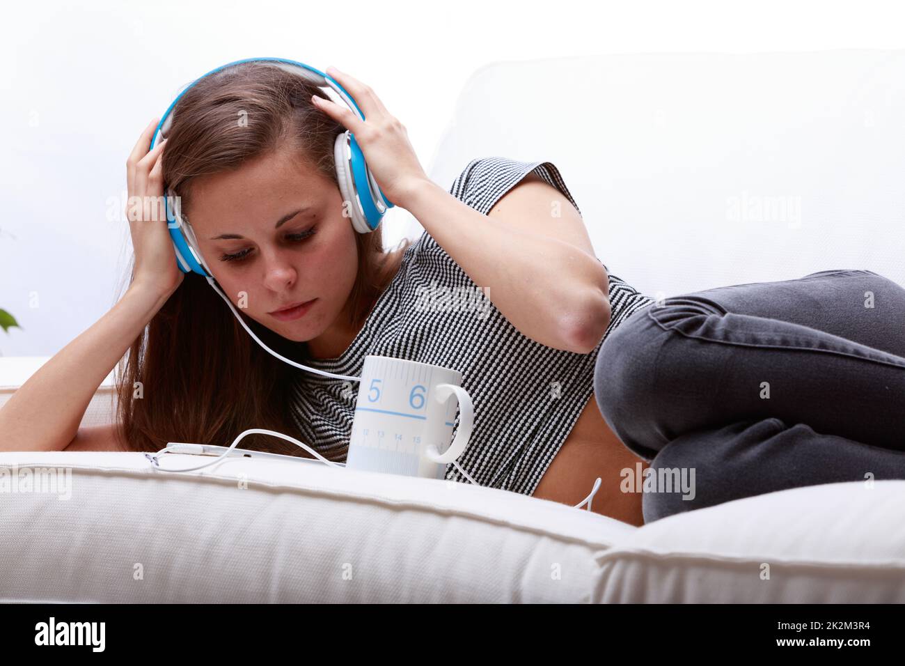 Attractive young woman listening to music on headphones Stock Photo