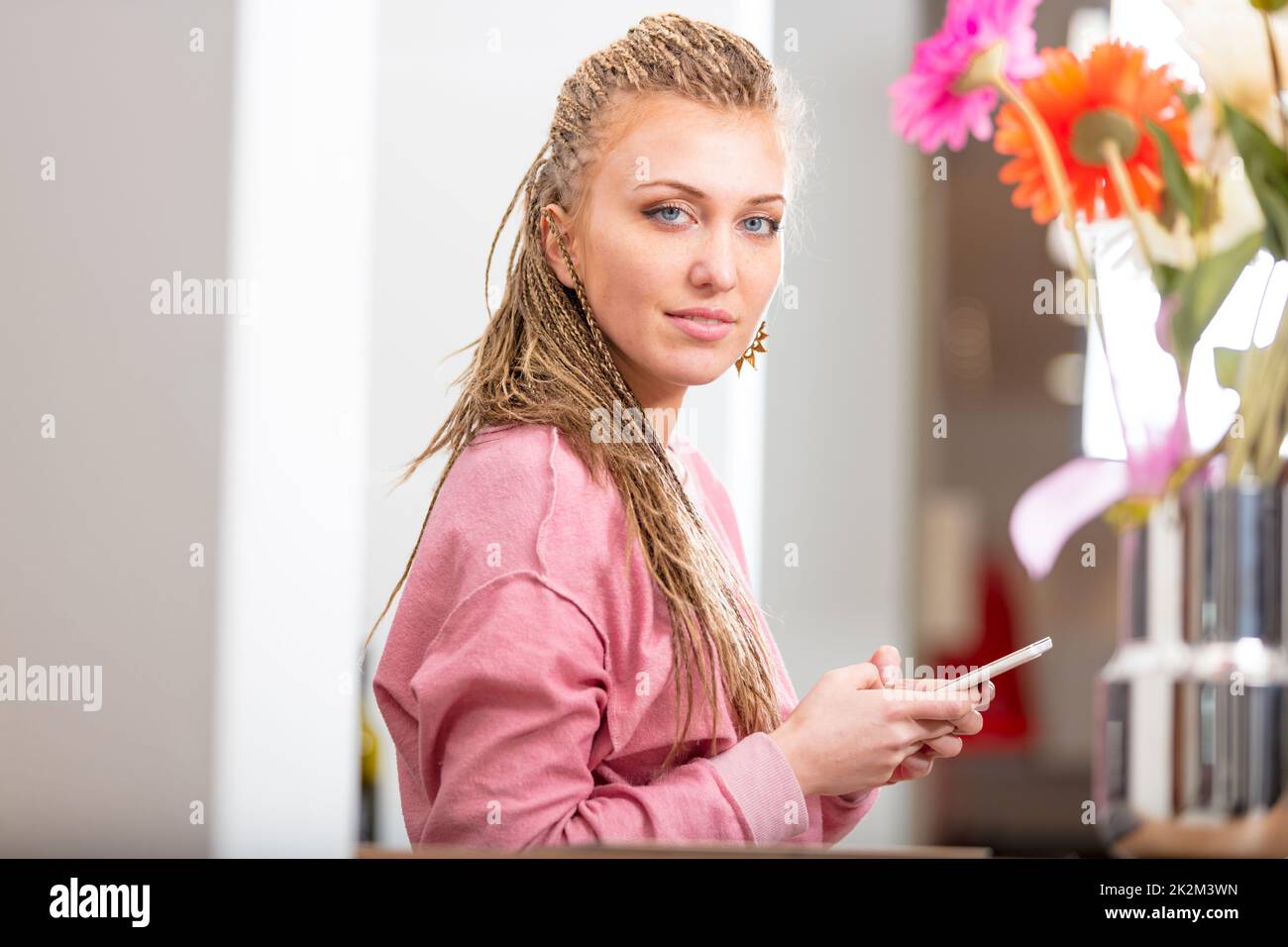 Pretty stylish young woman holding a mobile Stock Photo