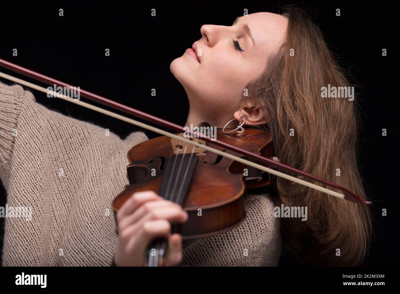 violinist woman playing with closed eyes Stock Photo