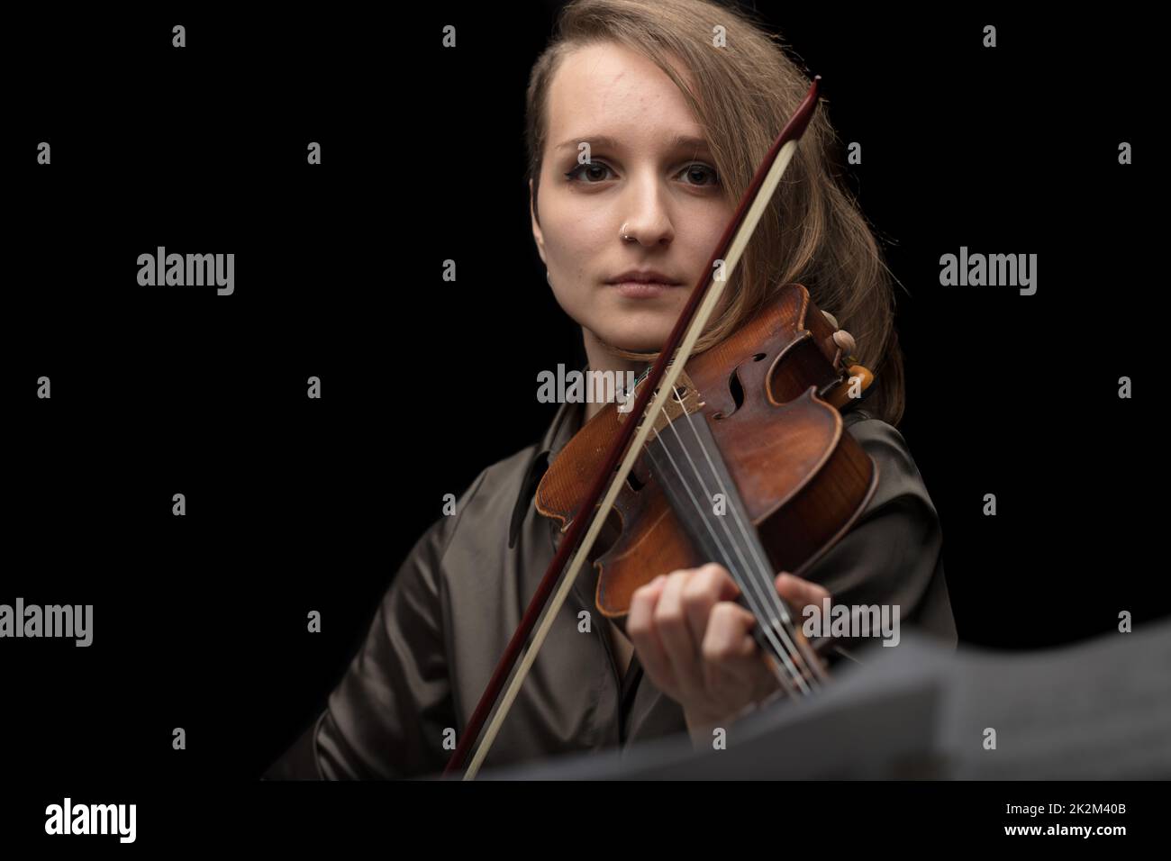 Attractive professional female violinist on black Stock Photo