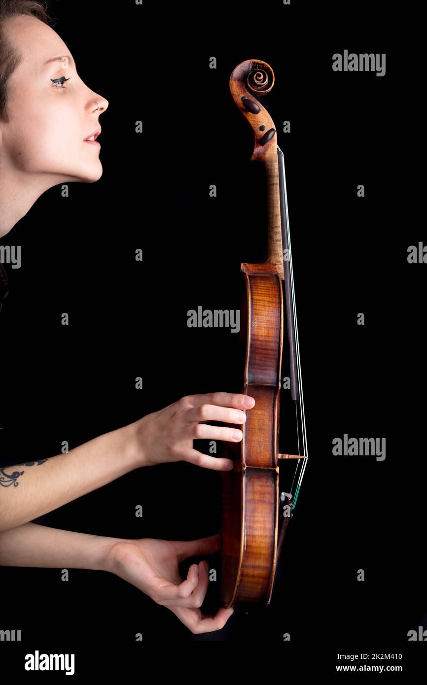 woman profile and violin on black background Stock Photo