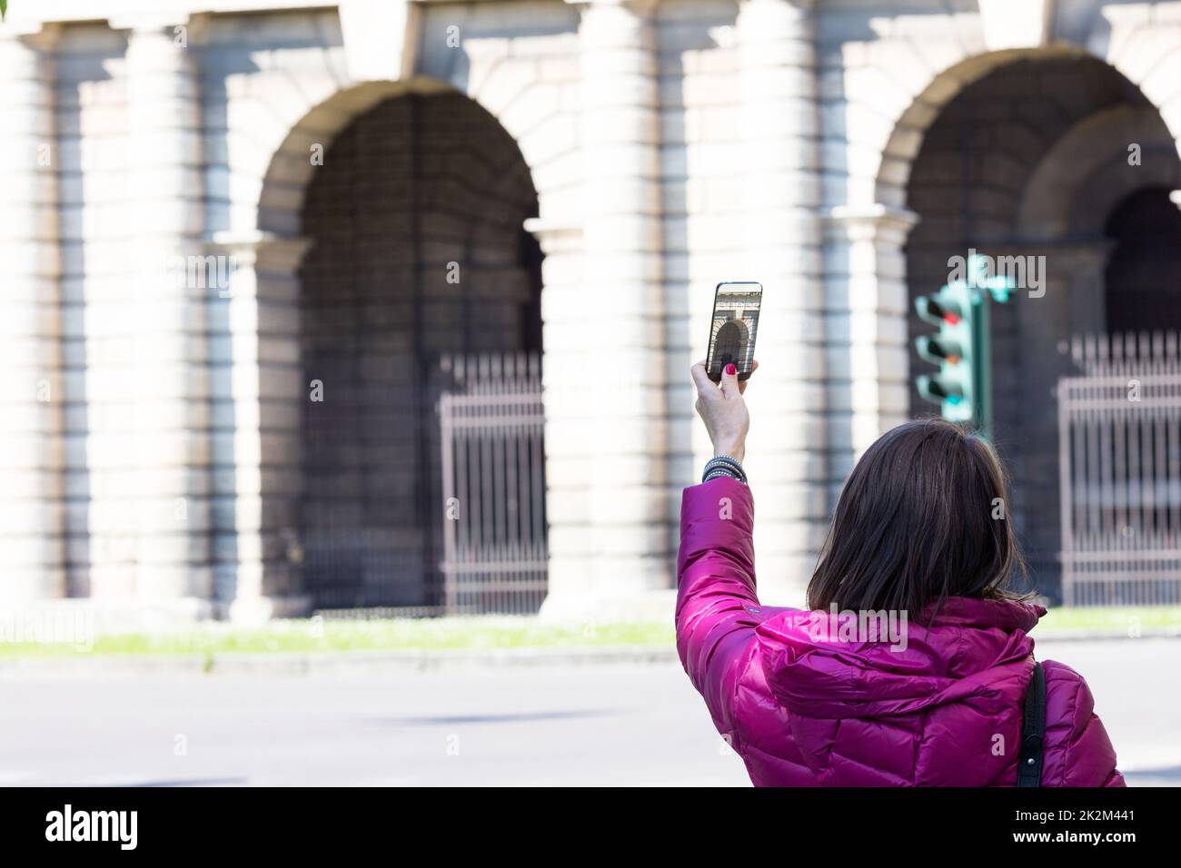 woman in a city taking photographs with transparent phone Stock Photo