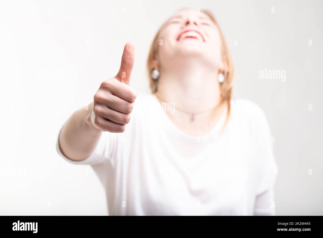 Elated excited woman giving a thumbs up Stock Photo