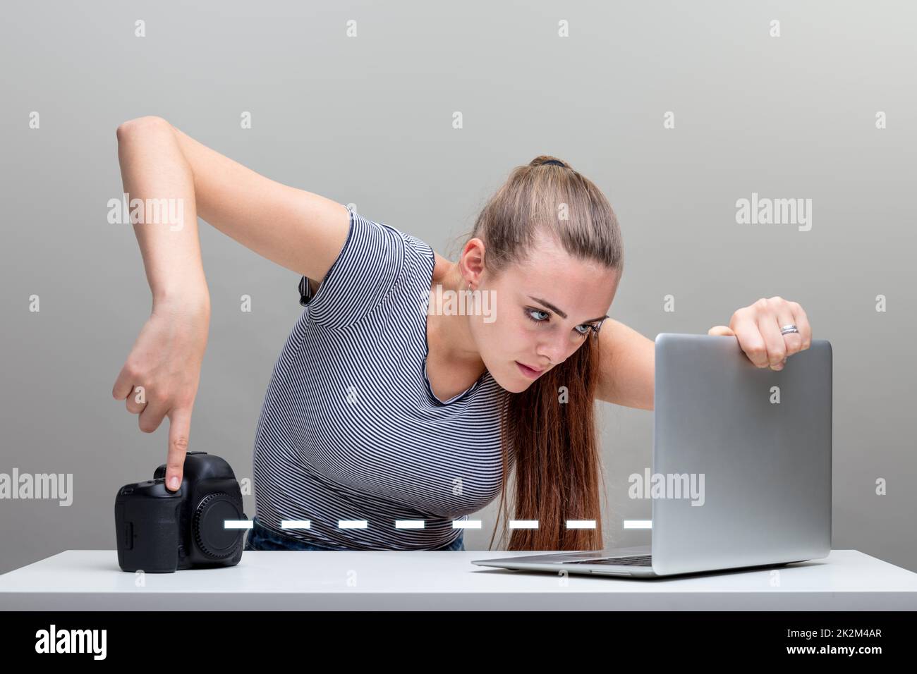 woman transfers pictures from her digital camera Stock Photo