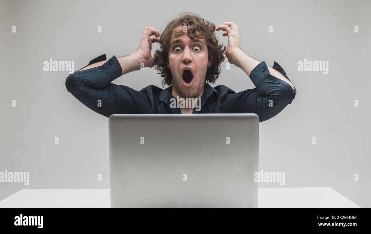 shocked man in front of his computer Stock Photo