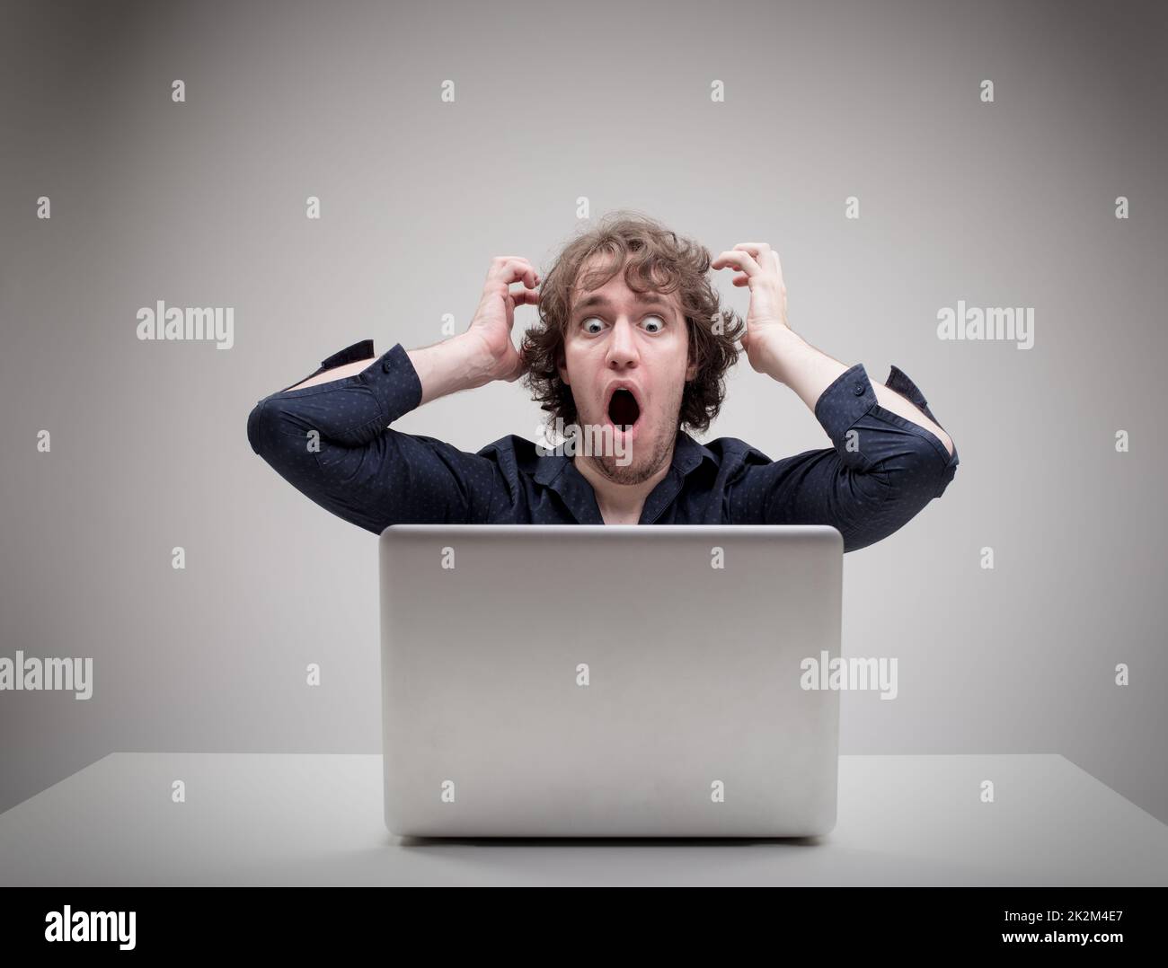 shocked man in front of his computer Stock Photo
