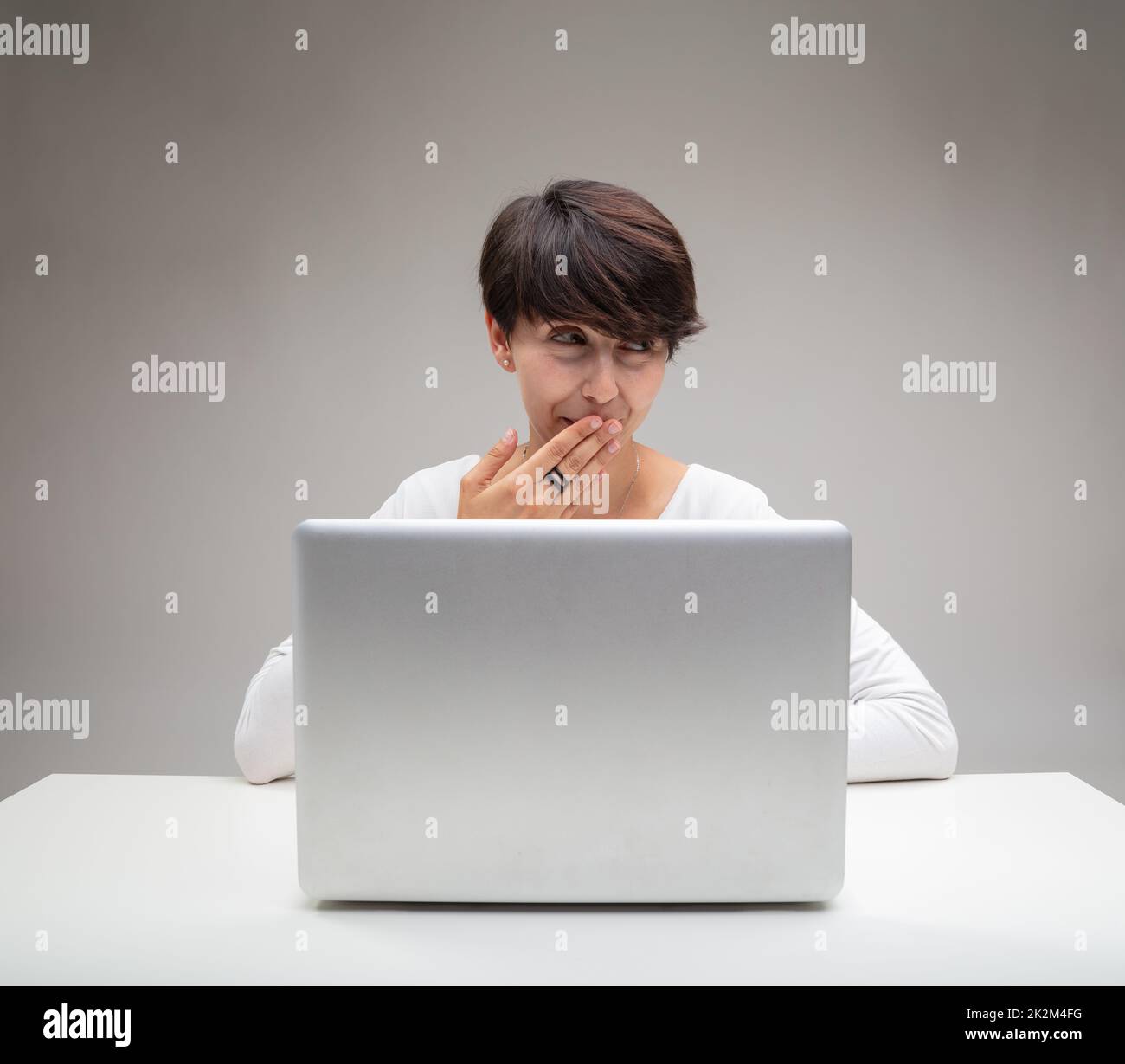 Amused businesswoman giggling to herself Stock Photo