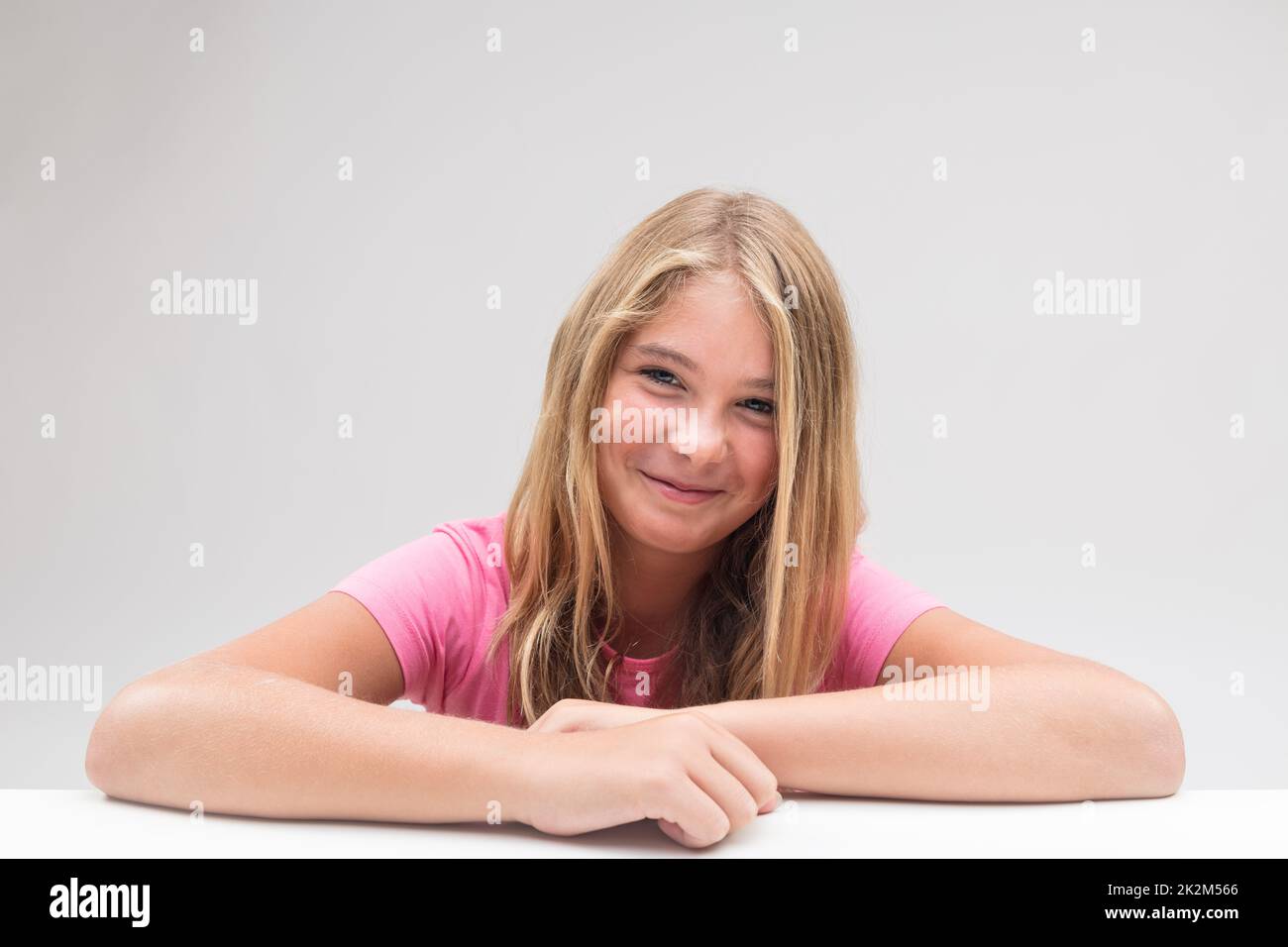 little girl grinning trying not to laugh Stock Photo