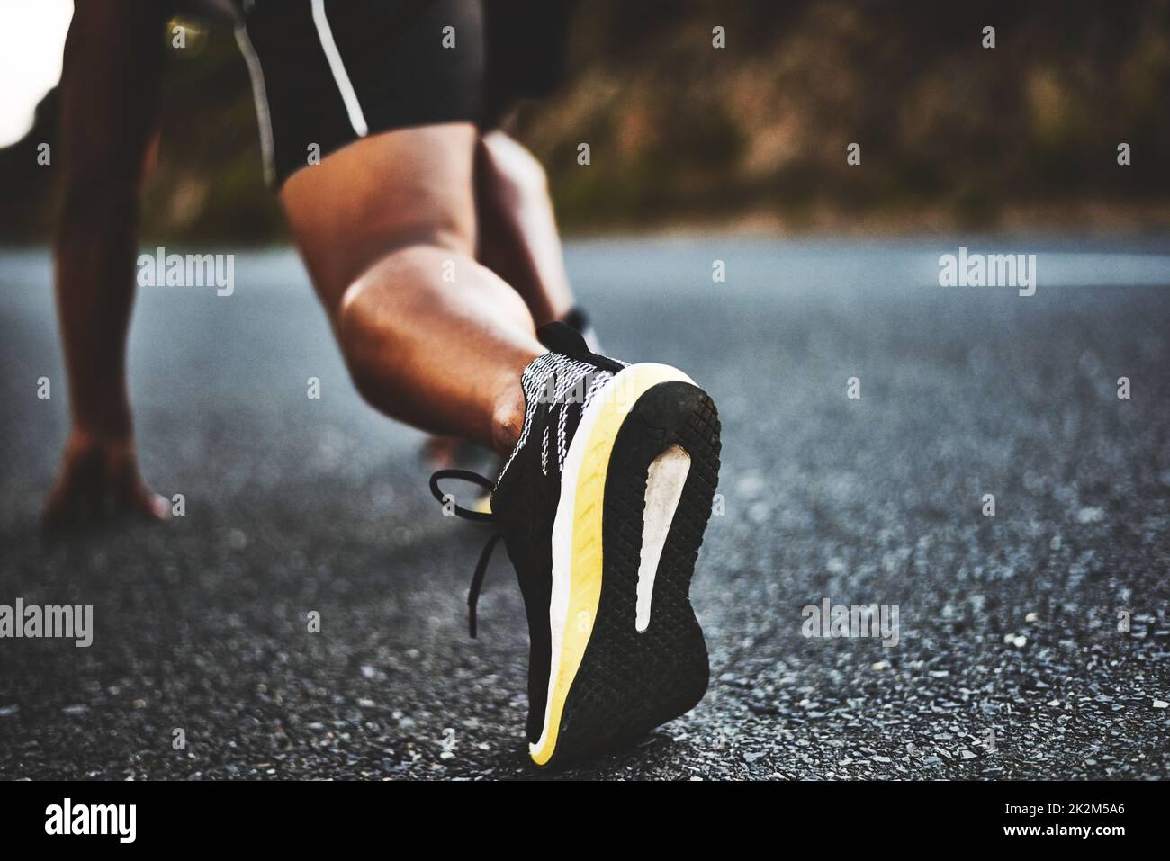 Nothing can stop me now. Low angle shot of a man out exercising on a tarmac road. Stock Photo