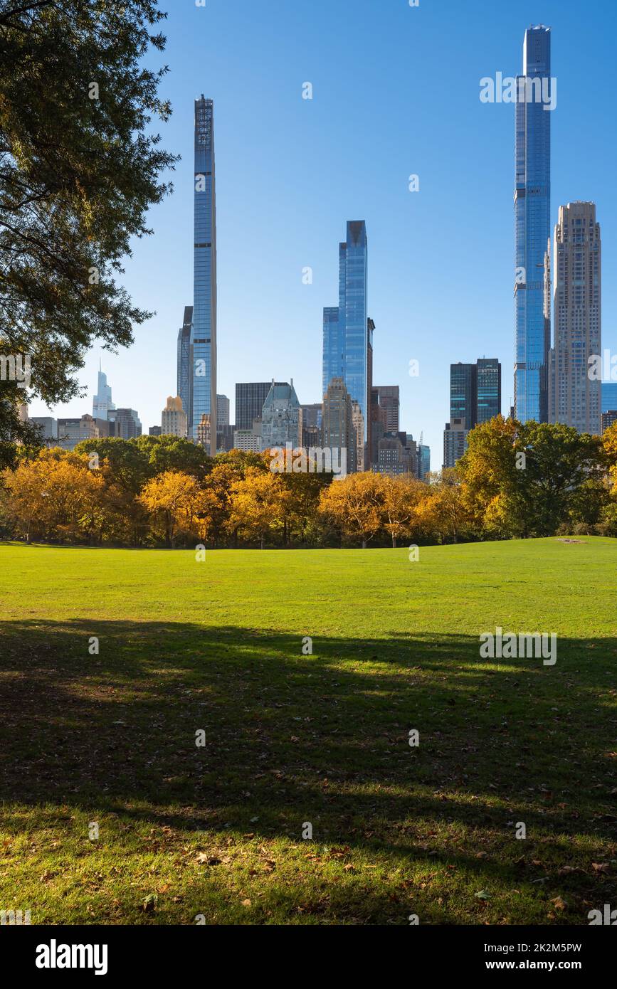 Midtown Manhattan view of Central Park in Fall with Billionaires' Row skyscrapers from Sheep Meadow. New York City Stock Photo