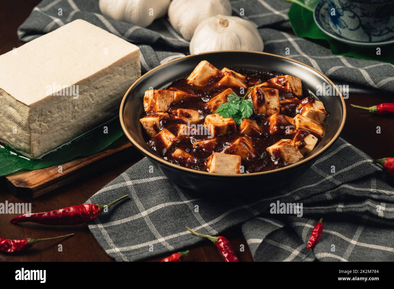 Traditional spicy hot chinese food,Mapo Tofu dressed with tea cup,on wooden plate with dark