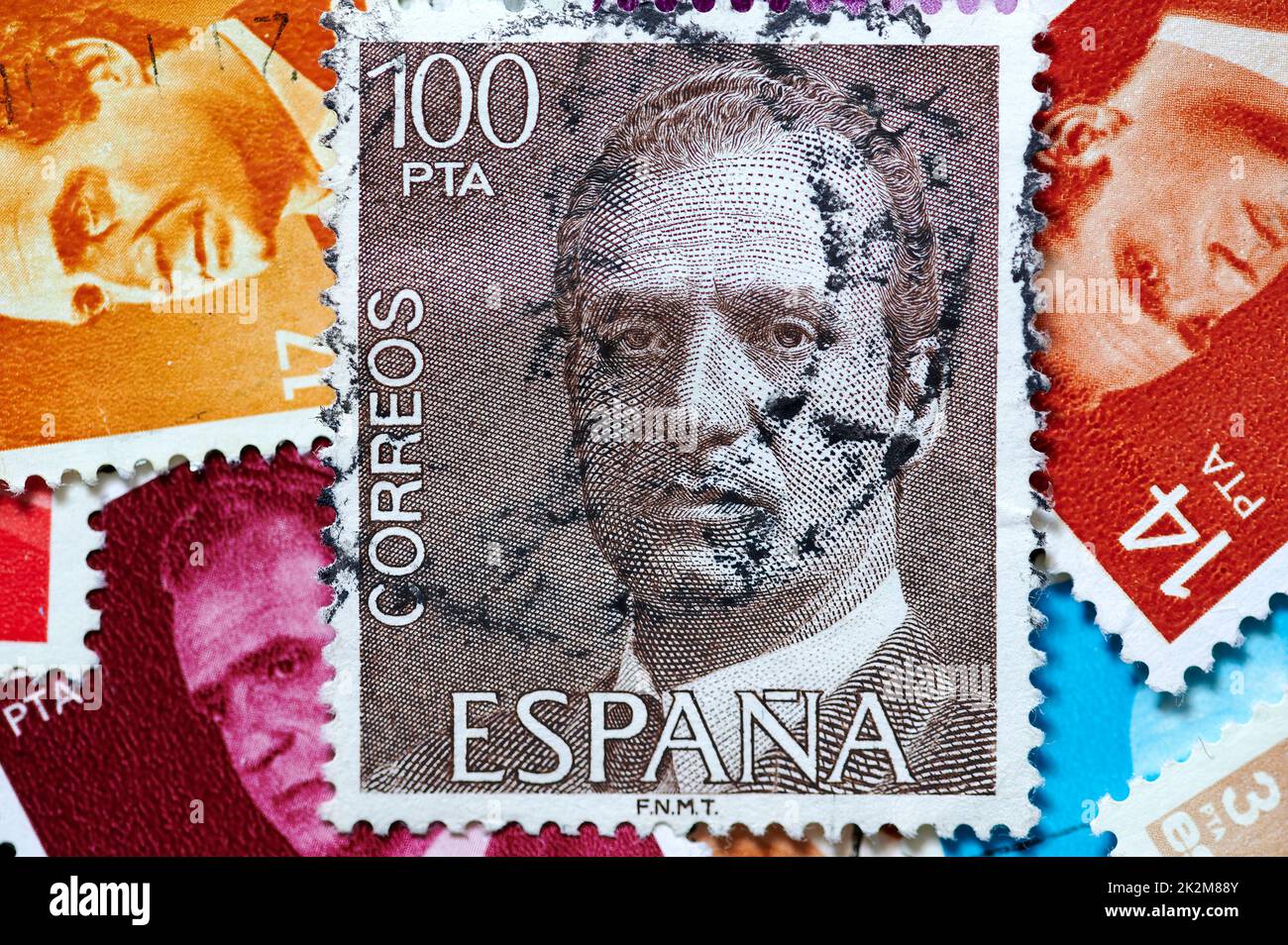 Madrid, Spain; 09-22-2022: Postage stamp with the portrait of the emeritus king of Spain Juan Carlos I with more stamps forming a background Stock Photo