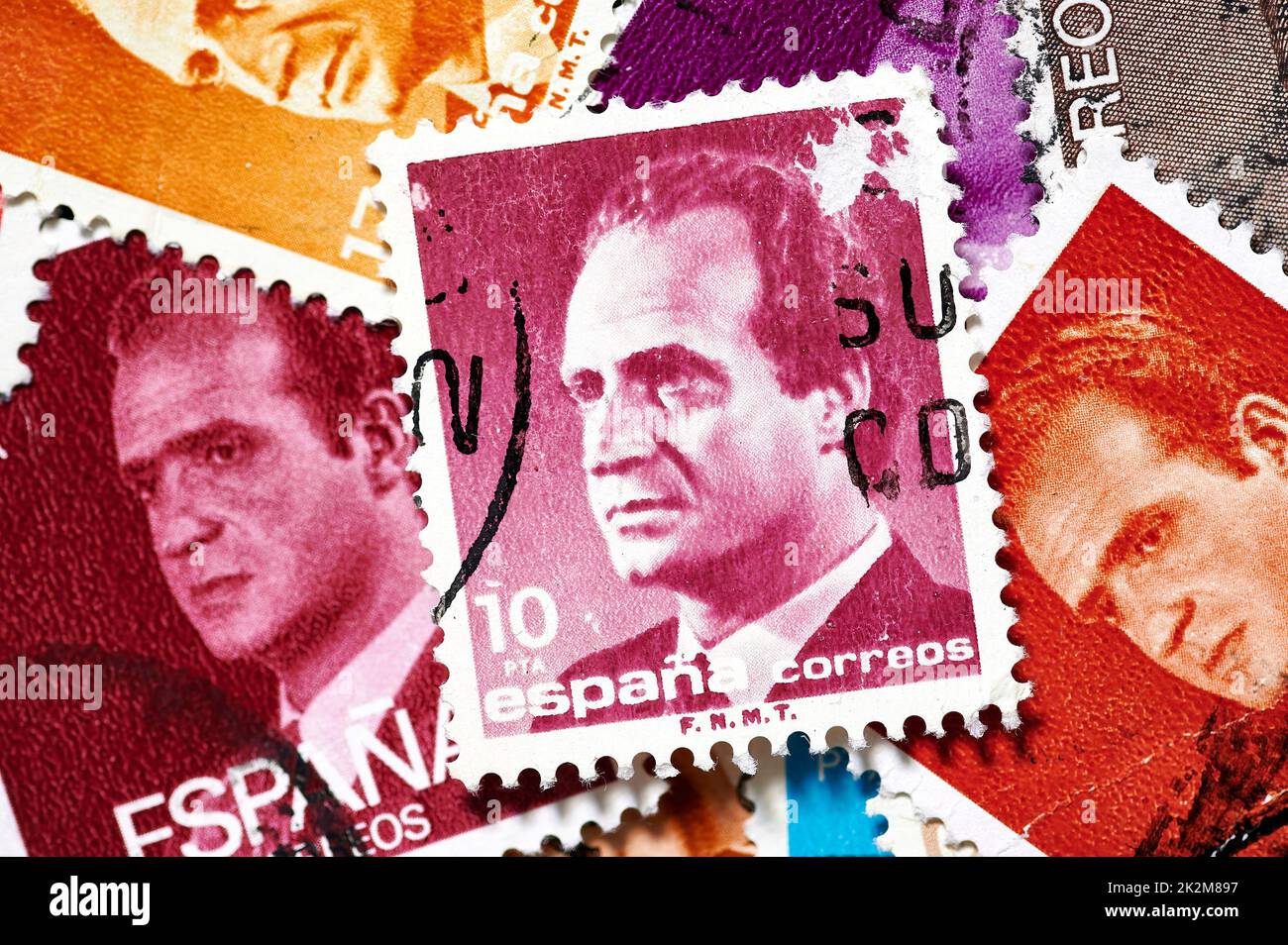 Madrid, Spain; 09-22-2022: Postage stamp with the portrait of the emeritus king of Spain Juan Carlos I with more stamps forming a background Stock Photo