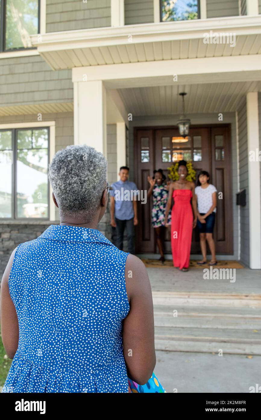 Woman visiting family waiting at front porch Stock Photo
