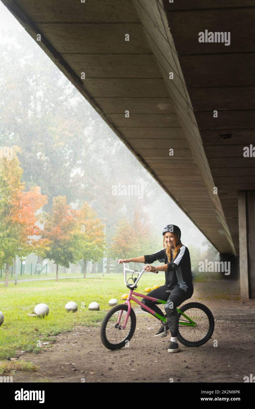Young active woman sitting on the freestyle bike Stock Photo