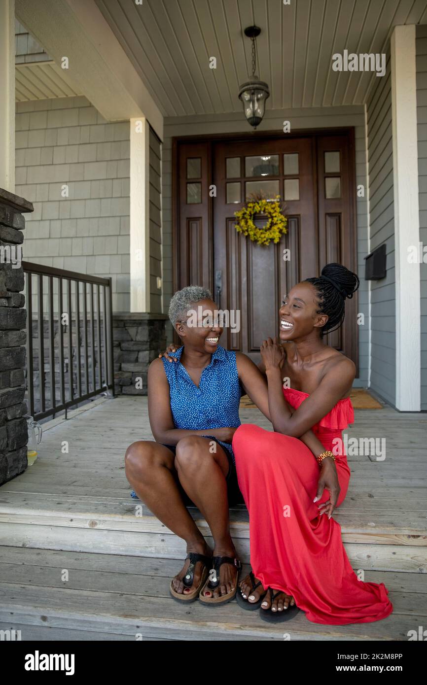 Portrait of mother and daughter sitting on front porch steps Stock Photo Alamy