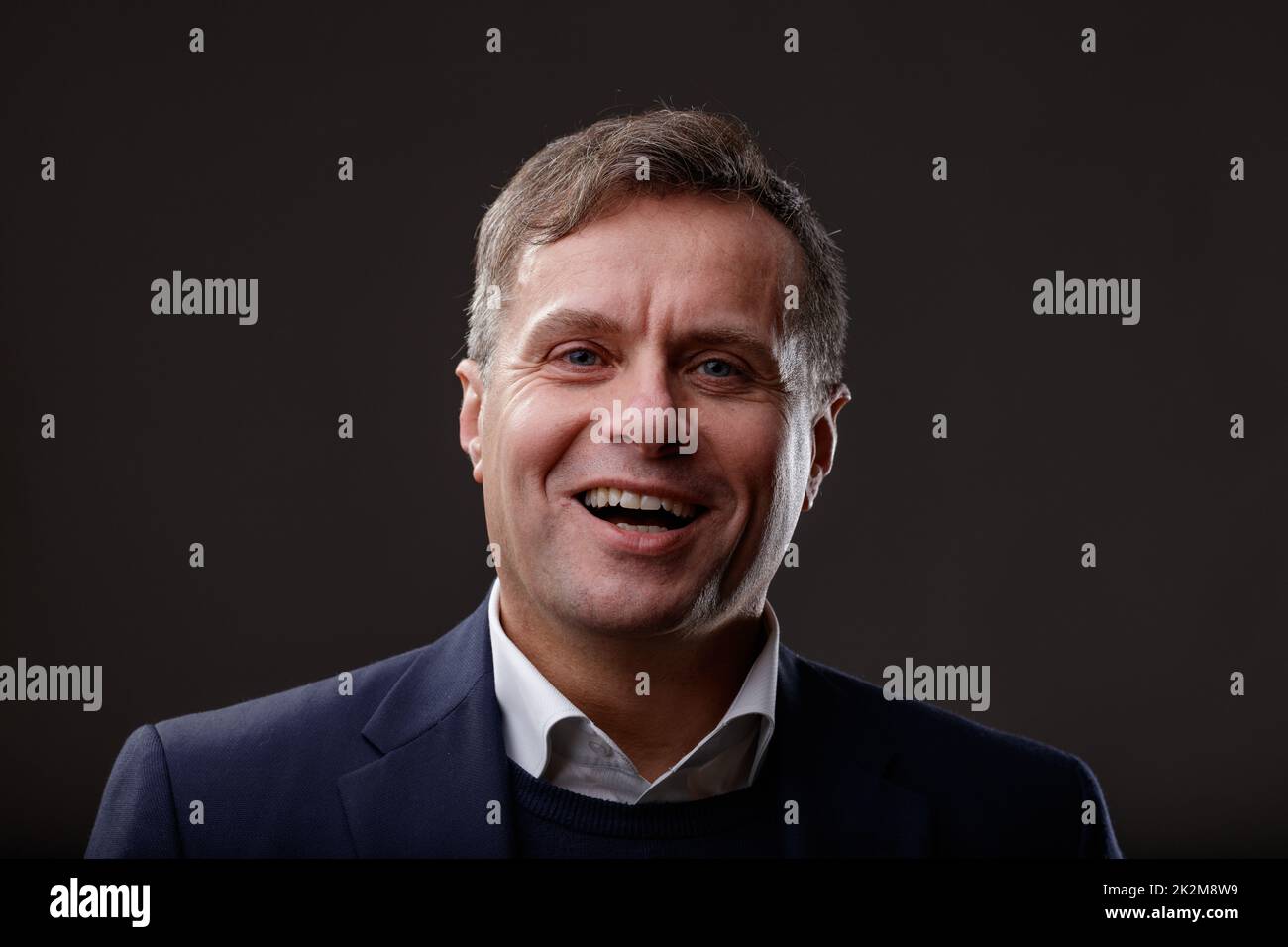 Professional stylish laughing middle-aged man studio portrait Stock Photo