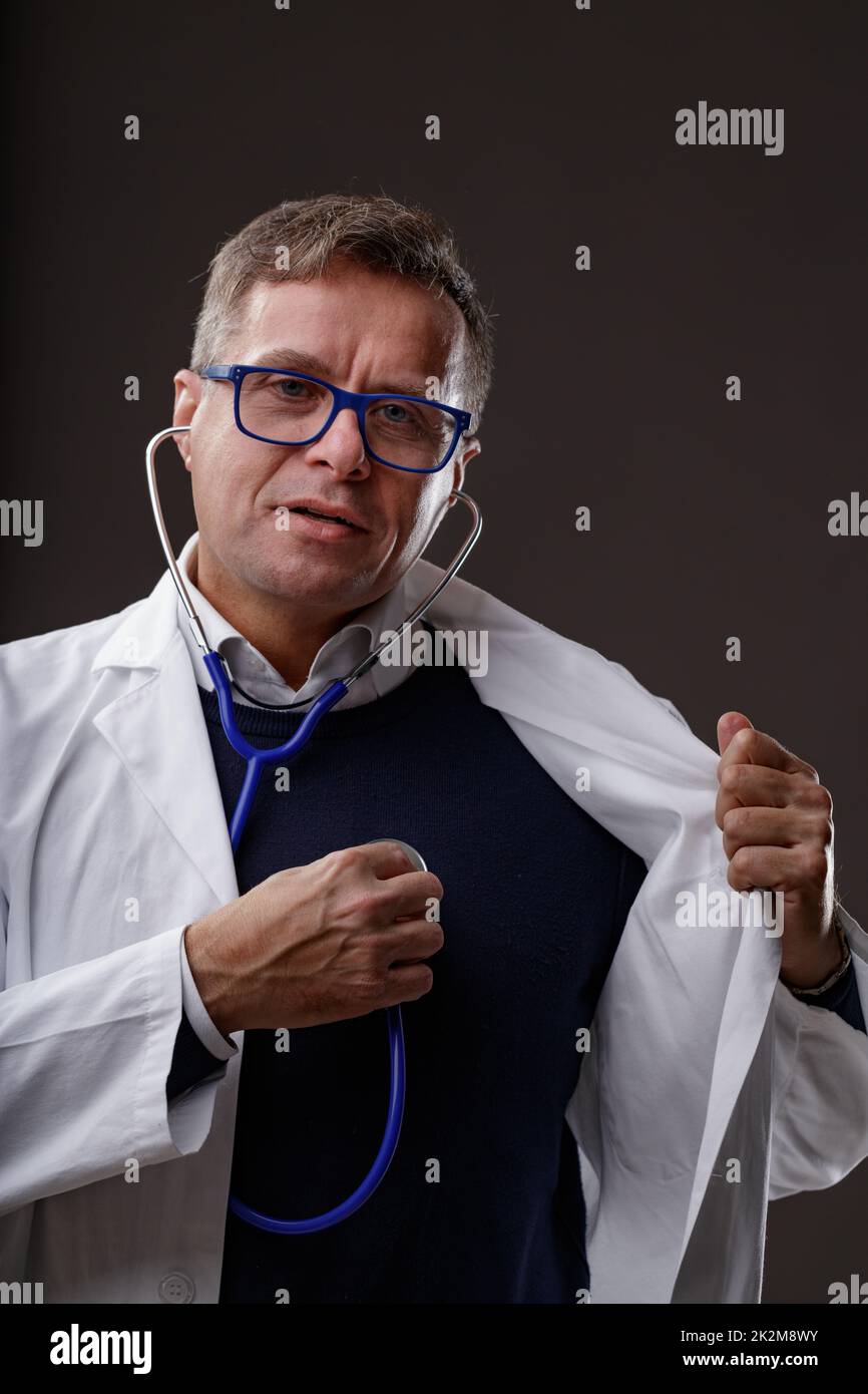 Doctor or cardiologist holding a stethoscope to his chest Stock Photo