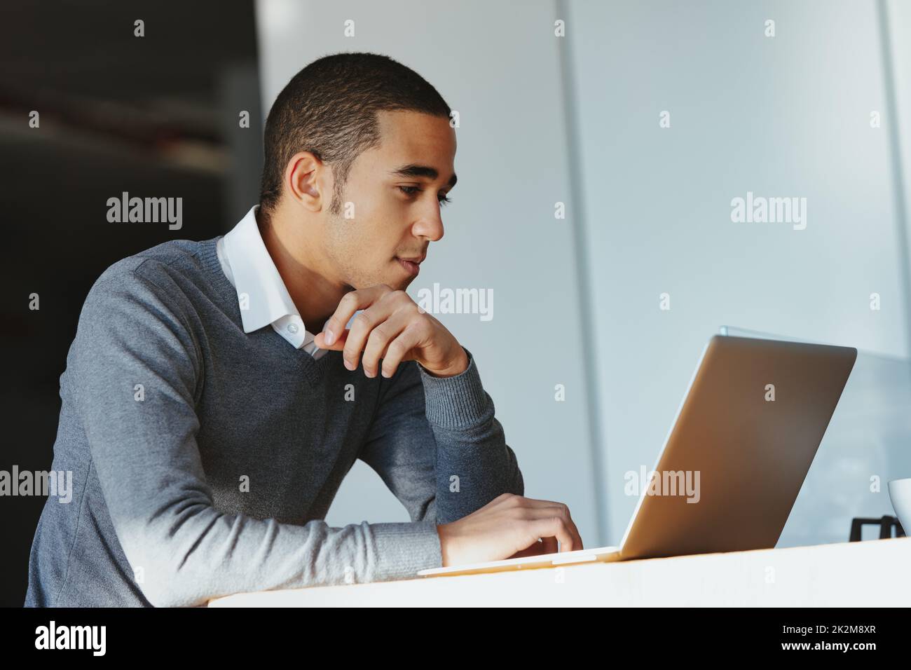 Low angle view of a Black businessman working on a laptop Stock Photo