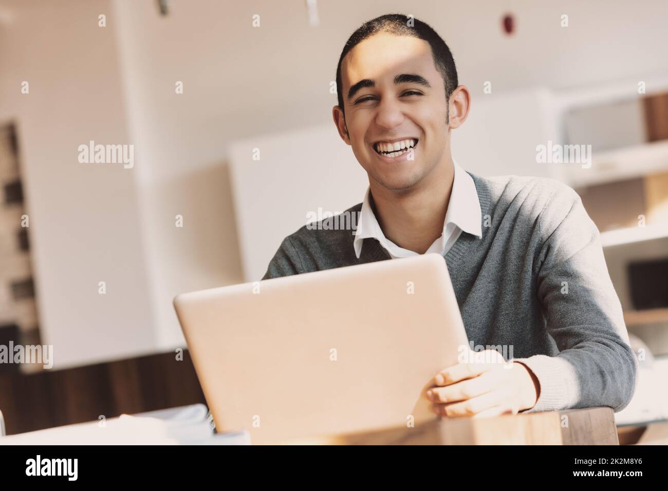 Happy young Black businessman laughing at the camera Stock Photo