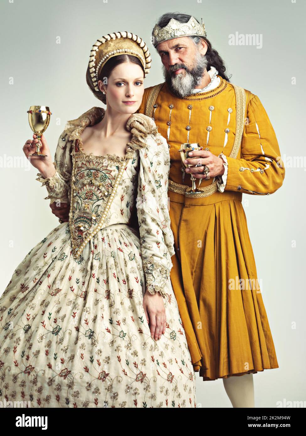 This is how we royals roll. Studio portrait of a king and queen drinking out of goblets. Stock Photo