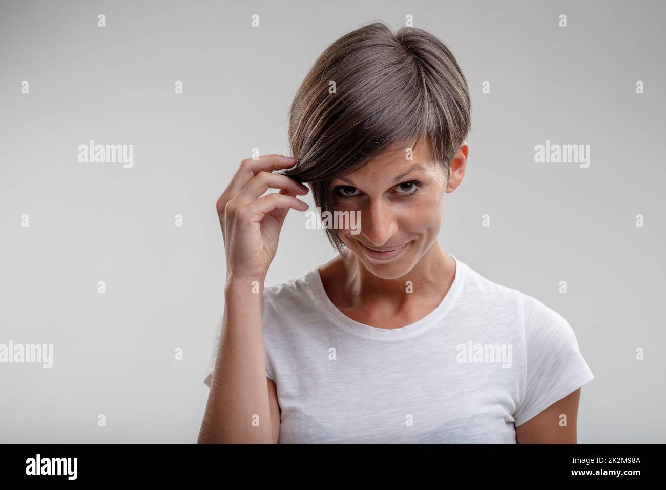 Mature woman holding aside her hair Stock Photo