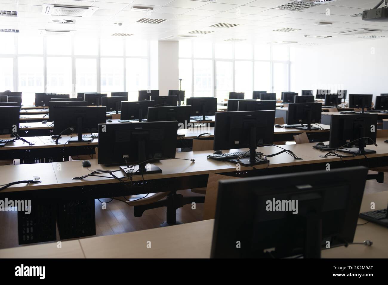 Empty classroom with lots of computers, or open workspace Stock Photo