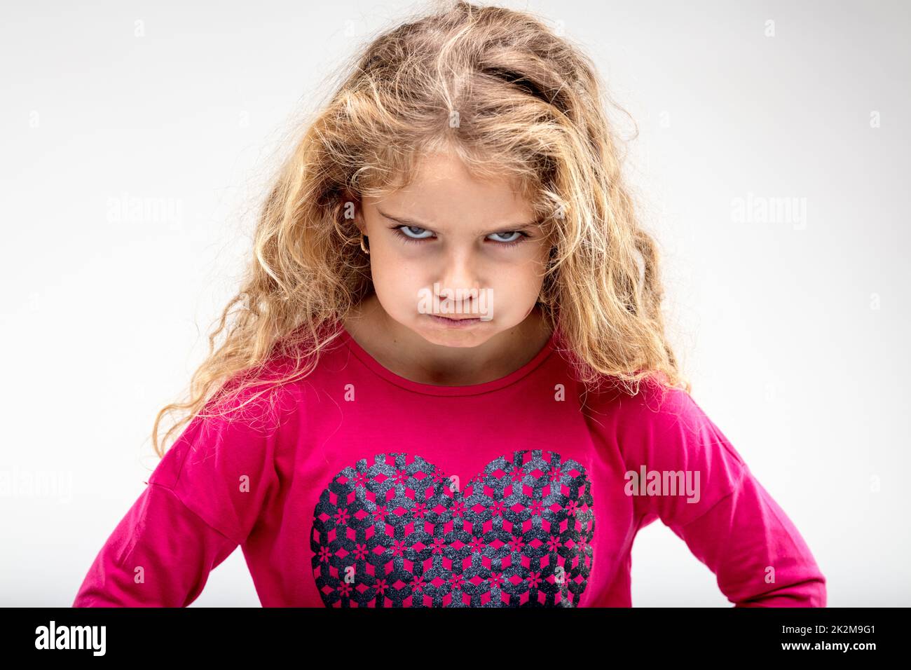 Preteen sulky girl making angry face Stock Photo