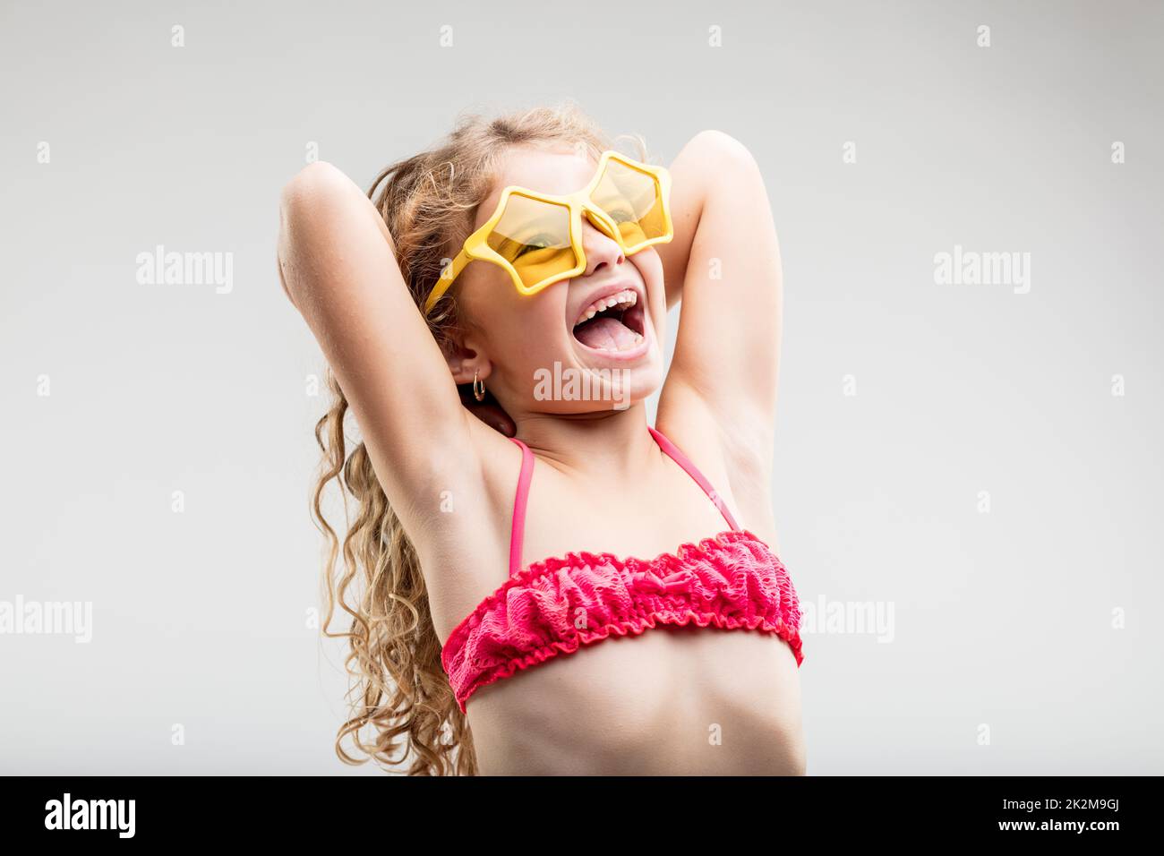 Vivacious fun little girl wearing trendy glasses Stock Photo