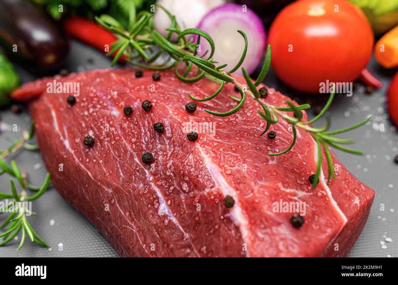 A piece of raw meat on a cutting board. Stock Photo