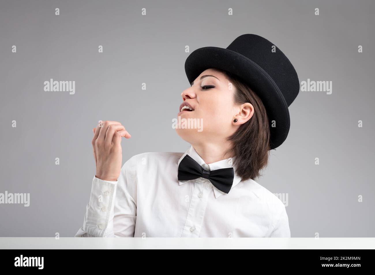 vain woman in top hat showing herself off Stock Photo
