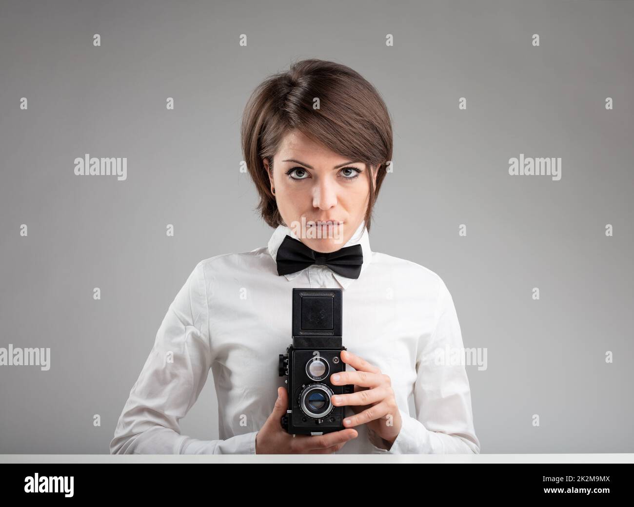 Stylish vintage female photographer Stock Photo