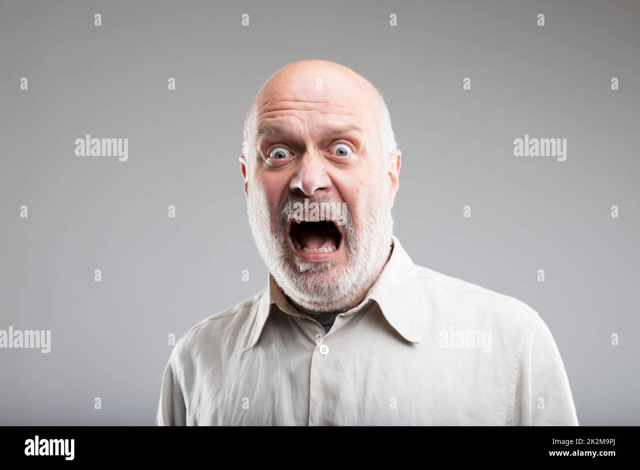 strong exaggerated fear expression of an old man Stock Photo