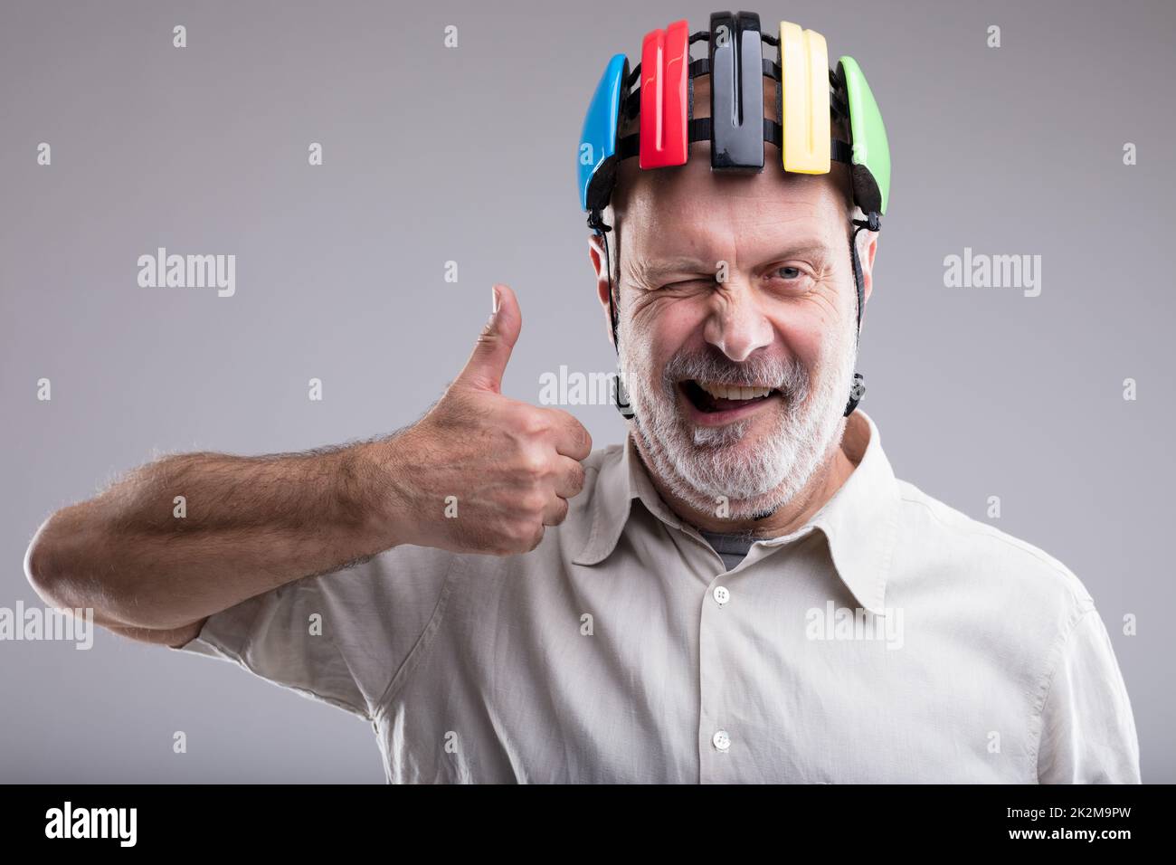 old man with bicicle head protection Stock Photo