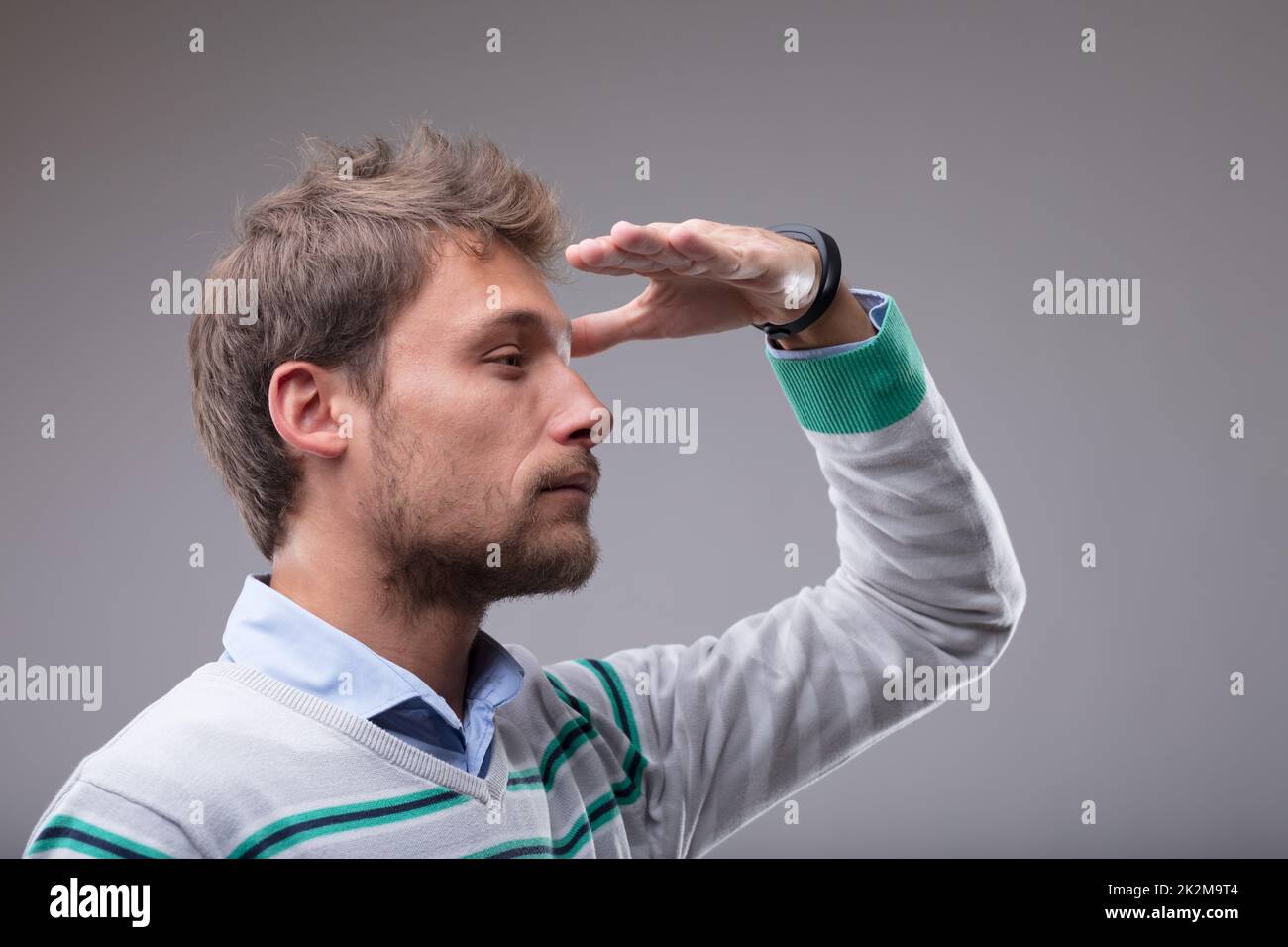 Blond man peering into the distance Stock Photo