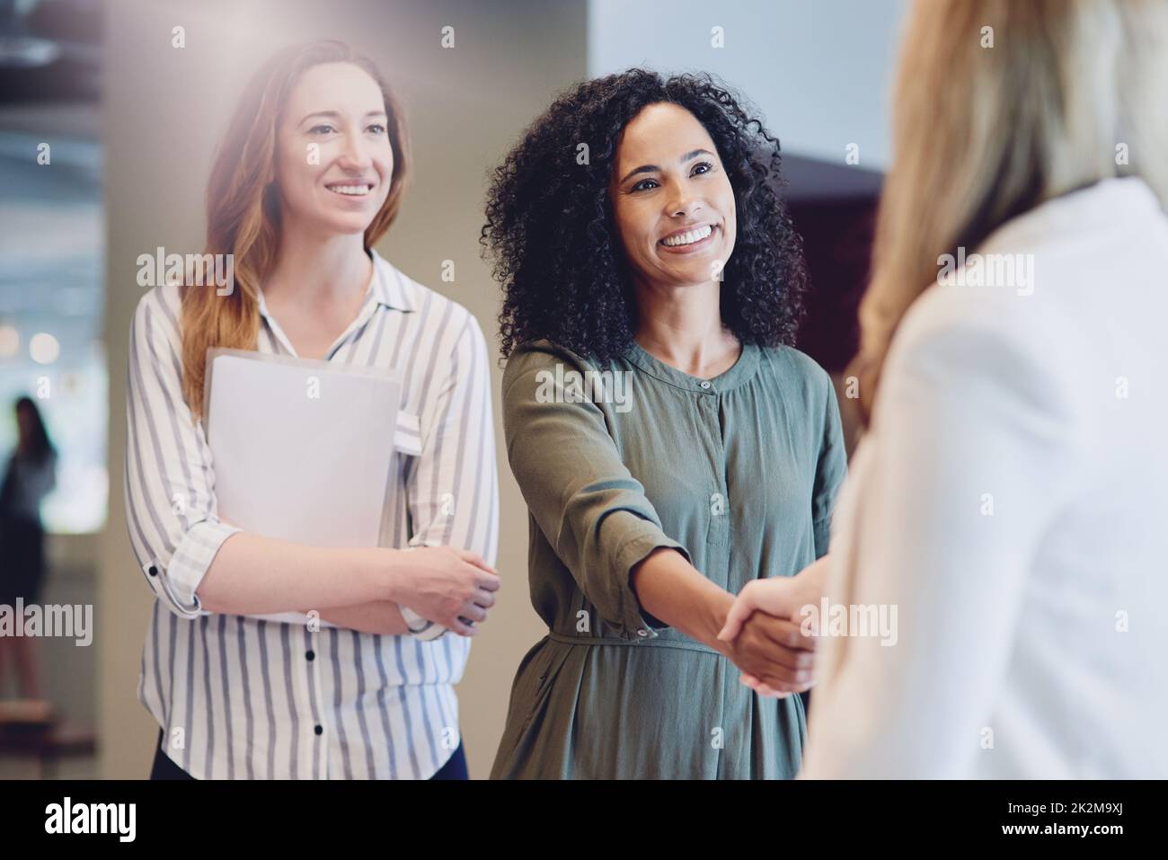 I look forward to working with you. Cropped shot of two young businesswomen shaking hands during